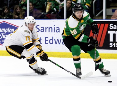 London Knights' Ryan Merkley (28) is chased by Sarnia Sting's Owen Saye (17) in the first period at Progressive Auto Sales Arena in Sarnia, Ont., on Sunday, Dec. 29, 2019. (Mark Malone/Postmedia Network)