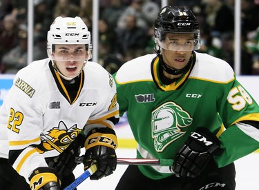 Sarnia Sting's Justin O'Donnell (22) battles London Knights' Bryce Montgomery (58) in the first period at Progressive Auto Sales Arena in Sarnia, Ont., on Sunday, Dec. 29, 2019. (Mark Malone/Postmedia Network)