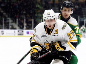 Sarnia Sting's Sean Josling (27) is checked by London Knights player Matvey Guskov (77) in the second period at Progressive Auto Sales Arena in Sarnia, Ont., on Sunday, Dec. 29, 2019. (Mark Malone/Postmedia Network)