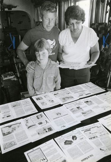 Frank and Nancy Prothero of Port Stanley and son Teddy stand before the pasted-up pages of their magazine The Great Lakes Fisherman, 1981. (London Free Press files)