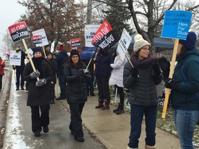 Oakridge Secondary School teachers carry picket signs outside the London school as public high school teachers across Ontario held a one-day strike. Photo taken on Wednesday Dec. 4, 2019. (Mike Hensen/The London Free Press)