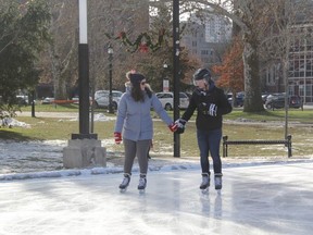 Sarah Tuer-Sipos and Cole Fenton take a leisurely skate around the newly opened outdoor rink at Victoria Park Saturday. The public rink is open 10 a.m. to 10 p.m. daily weather permitting.