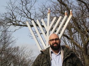 Joe Roberts, executive director of the Jewish Community Centre in London, stands in front of the towering menorah outside city hall on the third day of Hanukkah, Dec. 24, 2019. London's 6,000-strong Jewish community began celebrating the eight-day observance Dec. 22, 2019. (Jennifer Bieman/The London Free Press)