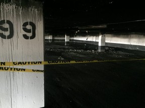 Police tape cordons off the area where an overnight car fire damaged an underground parking garage at an apartment complex on Kipps Lane. London police are calling the blaze suspicious. (Dale Carruthers, The London Free Press)