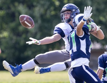 Cole Moore makes a valiant attempt  but can't quite make the one-handed catch while covered by Cole Manier in London on Thursday September 26, 2019. Moore's Parkside Stampeders fell to Manier's Laurier Rams, 29-22. (Derek Ruttan/The London Free Press)