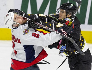 London Knights player Jonathan Gruden gets away with a cross-check to the chops of Connor Corcoran of the Windsor Spitfires in the first period of their game in London on Friday October 18, 2019. (Derek Ruttan/The London Free Press)
