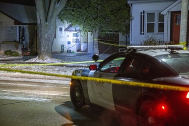 A police cruiser's headlights illuminate  a wide open door at 63 Simcoe Street in Exeter, Ontario where witnesses said a man was shot on Tuesday December 3, 2019. Derek Ruttan/The London Free Press/Postmedia Network