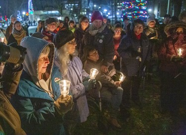 People gathered at the London Woman's Monument in Victoria Park to pay tribute to 14 women murdered at Ecole Polytechnique  on the 30th anniversary of the Montreal Massacre. (Derek Ruttan/The London Free Press)