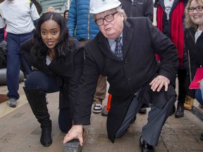 Ward 13 councillor Arielle Kayabaga and mayor Ed Holder place the final brick to complete construction of Dundas Place in downtown  London. More that 700,000 bricks and $16 million were used to transform Dundas Street between Wellington Street and Ridout Street  into a "flex street." Derek Ruttan/The London Free Press)