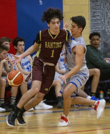 Mony Madlol of Oakridge runs into Banting ball carrier Matt Abbasey during their TVRA Central senior boys basketball game at Oakridge secondary school in London on Thursday. Banting won the game 53-41. (Derek Ruttan/The London Free Press)