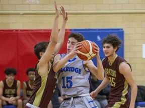 Oakridge ball carrier Adam Ladd runs into Michael Oh of Banting during their TVRA Central senior boys basketball game at Oakridge secondary school in London on Thursday. Banting won the game 53-41. (Derek Ruttan/The London Free Press)