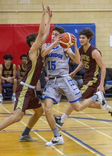 Oakridge ball carrier Adam Ladd runs into Michael Oh of Banting during their TVRA Central senior boys basketball game at Oakridge secondary school in London on Thursday. Banting won the game 53-41. (Derek Ruttan/The London Free Press)