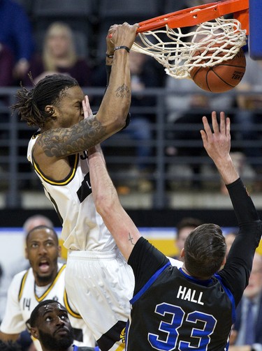 The London Lightning's AJ Gaines gets a face-full of fingers while dunking against Derek Hall of the Kitchener-Waterloo Titans during their NBL game in London on Tuesday April 9, 2019. (Derek Ruttan/The London Free Press)