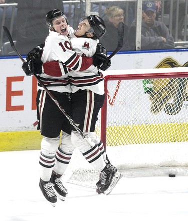 Guelph Storm players MacKenzie Entwistle (left) and Nick Suzuki jump for joy after Entwistle's empty-net goal cemented a 6-3 victory in Game 7 of their OHL playoff series against the London Knights on Tuesday April 16, 2019. The Storm came back to win the series after losing the first three games. The Storm went on to represent the OHL in the Memorial Cup. (Derek Ruttan/The London Free Press)