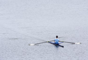 A rower skims across the surface of Fanshawe Lake in London on Sunday July 21, 2019. (Derek Ruttan/The London Free Press)