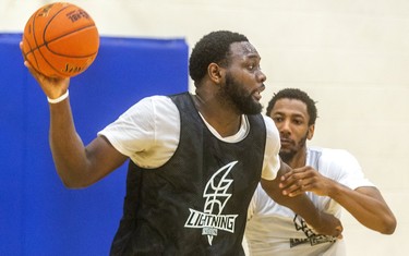 Lightning's Randy Phillips looks to pass while being guarded by Marcus Capers. New Lightning head coach Doug Plum, says this week is going to be a "grind for the guys," as they get up to speed during the first week of the London Lightning training camp  in London, Ont.  (Mike Hensen/The London Free Press)