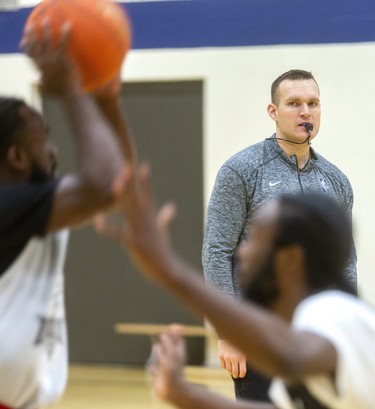 Lightning players run drills under the watchful eye of new Lightning head coach Doug Plum. Plum says this week is going to be a "grind for the guys," as they get up to speed during the first week of the London Lightning training camp  in London, Ont.  (Mike Hensen/The London Free Press)