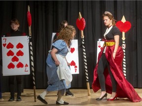 Alive (Michaela DiCicco) tried to keep her head as she curtsies to the Queen of Hearts (Sabrina Mills) during a student production of Lewis Carroll's Alice in Wonderland at Laurier secondary school. (Mike Hensen/The London Free Press)