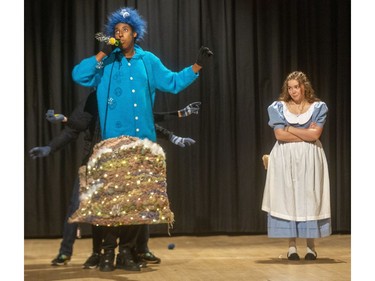 Alice (Michaela DiCicco) encounters a large caterpillar (Hussein Osman) in Laurier secondary school's production of Alice in Wonderland. (Mike Hensen/The London Free Press)