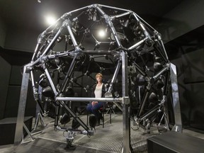 Ingrid Johnsrude a neuroscientist at Western sits inside her geodesic globe of speakers, that allows them to study how people differentiate between sounds in a noisy environment. The globe has a multitude of speakers and subwoofers to create an 360 degree encompassing sound environment. (Mike Hensen/The London Free Press)