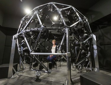Ingrid Johnsrude, a neuroscientist at Western University, sits inside her geodesic globe of speakers, which allows them to study how people differentiate between sounds in a noisy environment. (Mike Hensen/The London Free Press)
