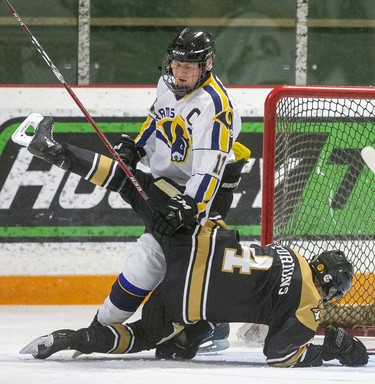 Hunter Nurse of the St. Joe's Rams holds his turn as he collides with Nolan Griffiths of the Holy Cross Centurions in front of the Holy Cross net during their game on Wednesday at Joe Thornton Arena in St. Thomas. (Mike Hensen/The London Free Press)