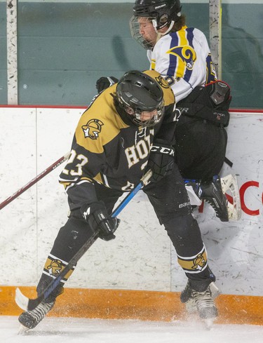 Tyler Raymond of the St. Joe's Rams gets hip-checked into the boards by Matt Lanting of the Holy Cross Centurions during their game on Wednesday at Joe Thornton Arena in St. Thomas. (Mike Hensen/The London Free Press)