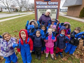 Wilton Grove PS teacher Courtney Boutillier and her kindergarten class show off their winter gloves, snow pants and boots which are part of a $2,000 donation. (Mike Hensen/The London Free Press)