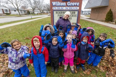 Wilton Grove PS teacher Courtney Boutillier and her kindergarten class show off their winter gloves, snow pants and boots which are part of a $2,000 donation. (Mike Hensen/The London Free Press)