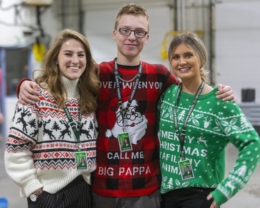 Samantha McLavin, Nik Tountas and Abby Dzuba work behind the scenes for the London Knights but got into Ugly Sweater Night at the Knights game against the Sarnia Sting at Budweiser Gardens in London on Friday. (Mike Hensen/The London Free Press)