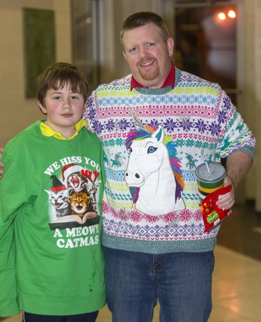 John Dale, 12, and Matt Dale take part in Ugly Sweater Night at the London Knights game against the Sarnia Sting at Budweiser Gardens in London on Friday. (Mike Hensen/The London Free Press)