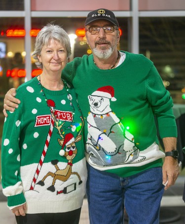 Karen Wilson and Frank Tore attend Ugly Sweater Night at the London Knights game against the Sarnia Sting at Budweiser Gardens in London on Friday. (Mike Hensen/The London Free Press)