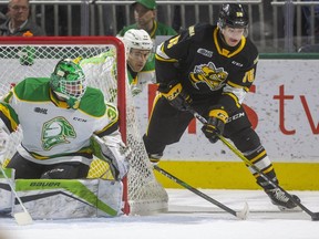 Nolan Burke of the Sting comes from behind the net being trailed by Matvey Guskov of the Knights with Dylan Myskiw in net in the first period of their game at Budweiser Gardens in London, Ont.  Photograph taken on Friday December 13, 2019.  Mike Hensen/The London Free Press/Postmedia Network