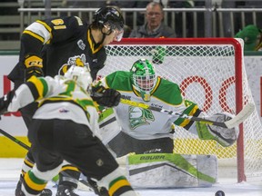 Knight's Dylan Myskiw tracks the puck as Anthony Tabak of the sting moves in while being checked by Nathan Dunkley in the first period of their game at Budweiser Gardens in London, Ont.  Photograph taken on Friday December 13, 2019.  Mike Hensen/The London Free Press/Postmedia Network