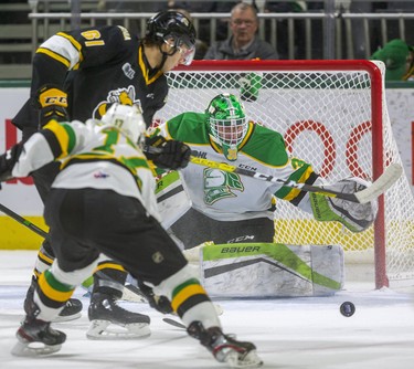 Knight's Dylan Myskiw tracks the puck as Anthony Tabak of the sting moves in while being checked by Nathan Dunkley in the first period of their game at Budweiser Gardens in London, Ont.  Photograph taken on Friday December 13, 2019.  Mike Hensen/The London Free Press/Postmedia Network