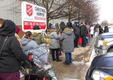 The Salvation Army Christmas Hamper started its five day run at the Western Fair Agriplex. Long lineups stretched the length of the building and beyond as people arrived early to get their Christmas hampers full of potatoes, carrots, turnips with gravy and stuffing and a $20 gift certificate for a turkey. They also got bags of gifts age appropriate for their children in London, Ont.  Photograph taken on Monday December 16, 2019.  Mike Hensen/The London Free Press/Postmedia Network