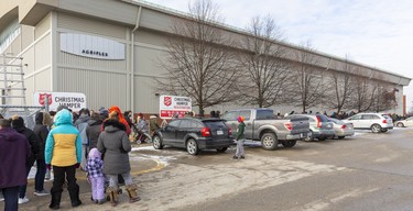 The Salvation Army Christmas Hamper started its five day run at the Western Fair Agriplex. Long lineups stretched the length of the building and beyond as people arrived early to get their Christmas hampers full of potatoes, carrots, turnips with gravy and stuffing and a $20 gift certificate for a turkey. They also got bags of gifts age appropriate for their children in London, Ont.  Photograph taken on Monday December 16, 2019.  Mike Hensen/The London Free Press/Postmedia Network