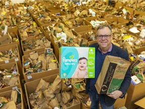 Wayne Dunn of Business Cares Food Drive stands in the  warehouse Tuesday Dec. 17, 2019 with the goods collected so far. The drive ends Friday and is running about 10 per cent behind last year. Dunn hopes a "little push" from Londoners will put them over the top. (Mike Hensen/The London Free Press)