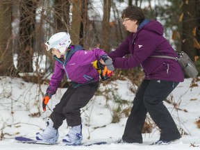 Jenna Sheppard catches up to her daughter Charlotte Sheppard on the beginner's hill at Boler Mountain on Thursday December 26, 2019.  Sheppard added some braking to her daughter who was on a snowboard for the first time, although she already knows how to ski. (Mike Hensen/The London Free Press)