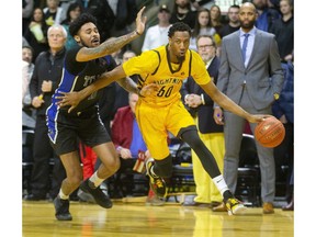 Marcus Capers of the Lightning drives around Jared Nickens of the Kitchener-Waterloo Titans in London, Ont.  As the Lightning kicked off their season at Budweiser Gardens on Friday December 27, 2019. (Mike Hensen/The London Free Press)