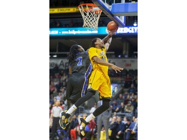 Marcus Capers of the Lightning goes up against Nigel Tygther of the Kitchener-Waterloo Titans during their home opener game at Budweiser Gardens in London, Ont. on Friday Dec. 27, 2019.  (Mike Hensen/The London Free Press)