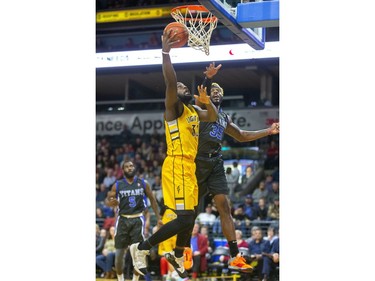 Randy Phillips of the Lightning goes up against Jonathan Harris of the Kitchener-Waterloo Titans during the Lightning's home opener game at Budweiser Gardens in London, Ont. on Friday Dec. 27, 2019.  (Mike Hensen/The London Free Press)