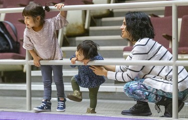 Vienna Diaz, 3, her little sister Madilyn, 1, and their mom Kathleen Diaz watch the Purple and White basketball tournament at Alumni Hall on Sunday December 29, 2019. 
Diaz's husband coaches for St. Paul out of Mississauga. It was the 62nd annual Purple and White basketball tournament, which wrapped up Sunday, Mike Hensen/The London Free Press/Postmedia Network