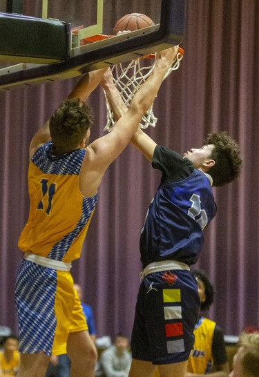 Beal's Oscar Pensa is blocked from a dunk by St. Joseph's Brayden Walls during their consolation semi-final that they won 67-48 Sunday at Alumni Hall.
They were playing in the 62nd annual Purple and White basketball tournament in London. Photograph taken on Sunday December 29, 2019. 
Mike Hensen/The London Free Press/Postmedia Network