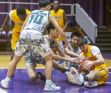 Milan Jaksic of Kennedy Collegiate in Windsor comes up with the loose ball after a scramble in the Mississauga St. Paul key during their semi-final at Alumni Hall in the 62nd annual Purple and White basketball tournament in London. Kennedy won 67-48. Photograph taken on Sunday December 29, 2019. 
Mike Hensen/The London Free Press/Postmedia Network