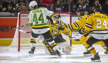 Jonathan Gruden swings at a bouncing rebound but can't make contact in front of Sarnia's Ethan Langevin as Kelton Hatcher and Marko Jakovljevic move in during their New Year's Eve game Tuesday afternoon at Budweiser Gardens in London, Ont. 
Photograph taken on Tuesday December 31, 2019. 
Mike Hensen/The London Free Press/Postmedia Network