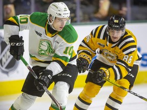 Stuart Rolofs of the Knights keeps the puck in the Sarnia zone while being chased by Nolan Burke of the Sting during their New Year's Eve game Tuesday afternoon at Budweiser Gardens in London. Mike Hensen/The London Free Press/Postmedia Network