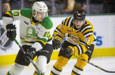 Stuart Rolofs of the Knights keeps the puck in the Sarnia zone while being chased by Nolan Burke of the Sting during their New Year's Eve game Tuesday afternoon at Budweiser Gardens in London. Mike Hensen/The London Free Press/Postmedia Network