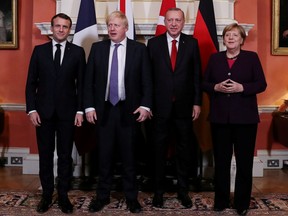 France's President Emmanuel Macron, Britain's Prime Minister Boris Johnson, Turkish President Tayyip Erdogan and German Chancellor Angela Merkel pose as they meet at Downing Street ahead of the NATO summit in London, Britain, December 3, 2019. (Murat Cetinmuhurdar/Presidential Press Office/Handout via REUTERS)