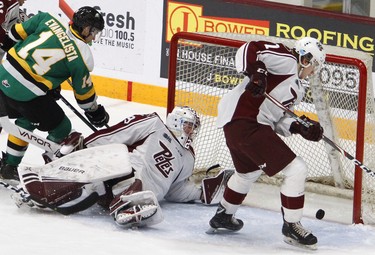 Peterborough Petes' goalie Hunter Jones watches the puck bounce on the goal line against London Knights' Luke Evangelista cleared by Shawn Spearing during first period OHL action on Thursday December 5, 2019 at the Memorial Centre in Peterborough, Ont. (Clifford Skarstedt, Postmedia Network)